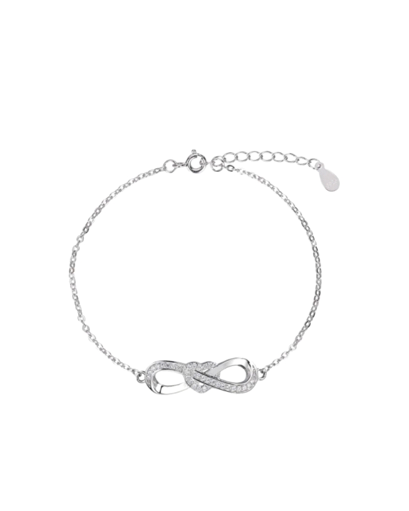 La pulsera de plata rodiada con un símbolo de infinito, adornado con circonitas y un corazón, es una expresión encantadora de am