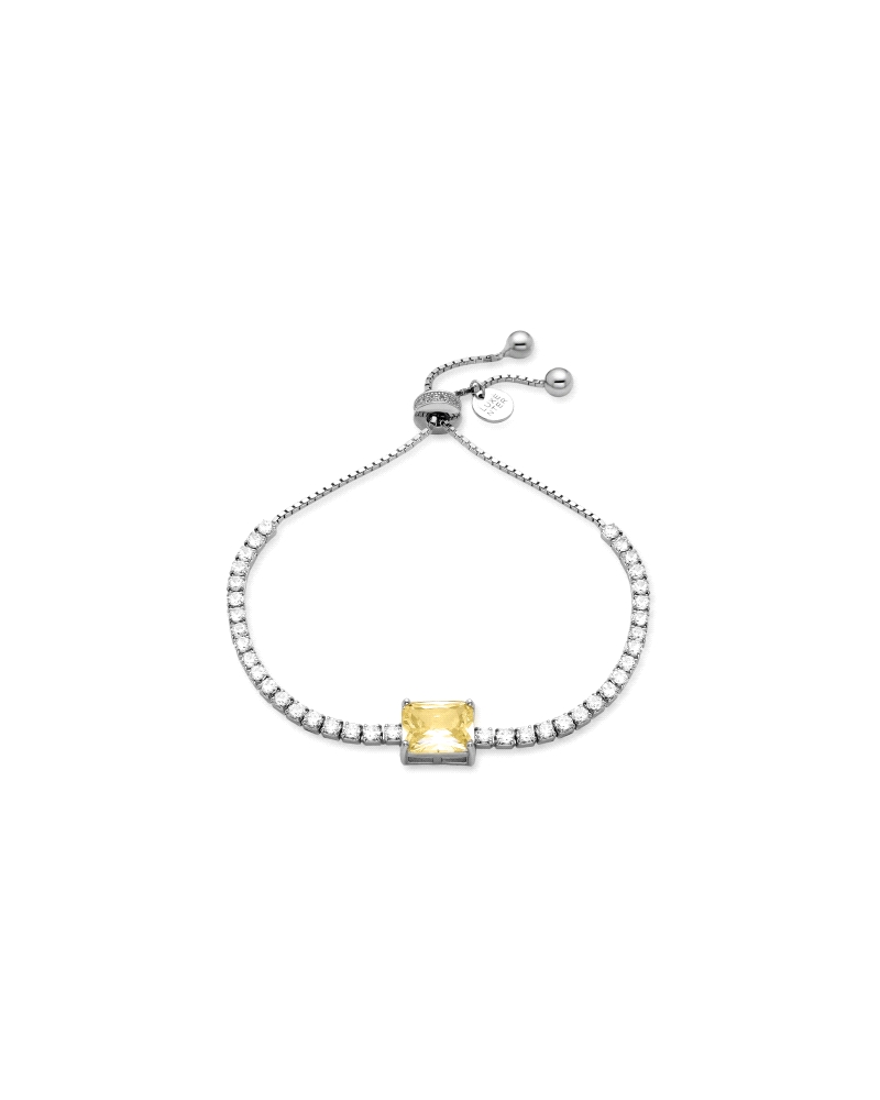 Pulsera elaborada en plata de ley con circonitas blanca y un cristal amarillo central. Cierre ajustable.