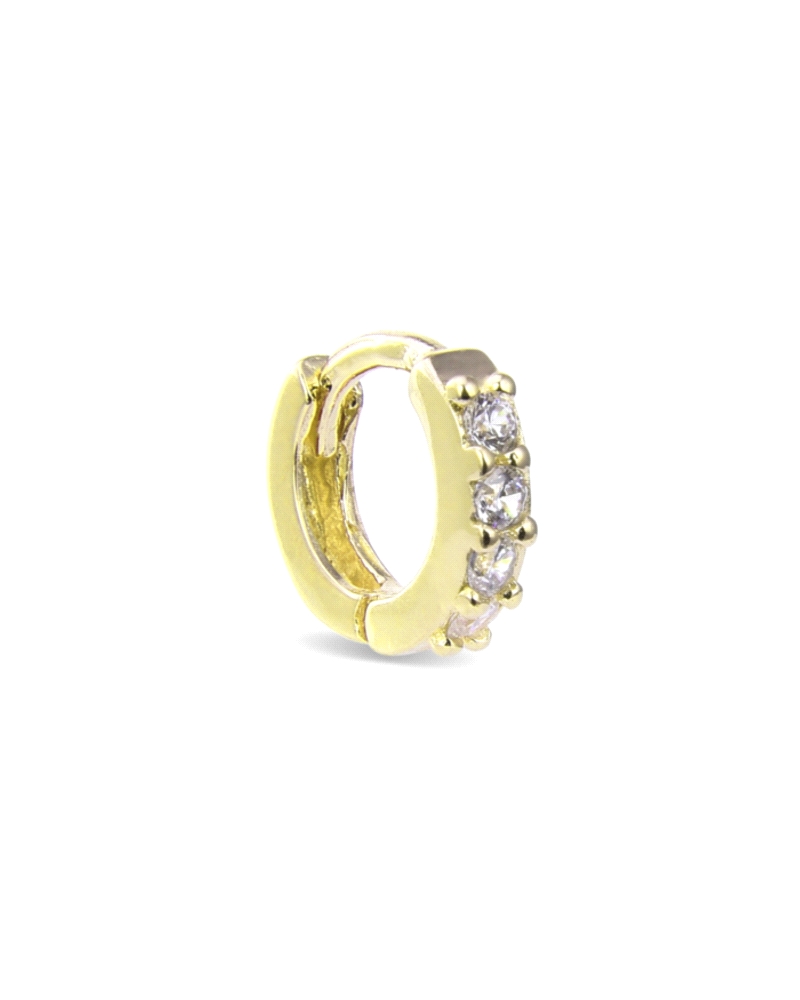 Este piercing está fabricado en plata de ley con un elegante baño de oro amarillo, realzado por tres circonitas blancas que apor
