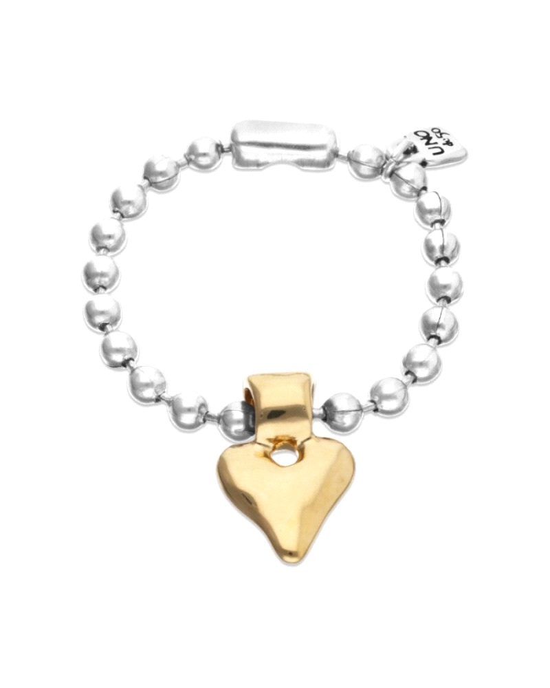 Pulsera UNOde50 para mujer modelo Pálpito compuesta por cadena de bolas bañadas en plata con un corazón colgante bañado en oro a